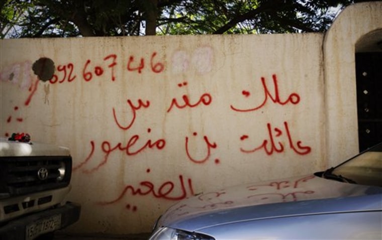 Graffiti on the wall of a house reads in Arabic, "house of bin Mansour," in Tripoli, Libya. Across the city, gunmen have turned up at houses demanding ownership — a sign of the post-revolutionary disorder rattling this oil-rich nation. 